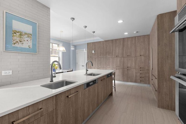 kitchen featuring tasteful backsplash, modern cabinets, light countertops, and a sink