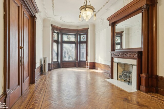 foyer with parquet floors and a notable chandelier