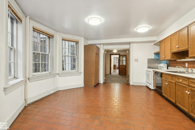 kitchen with sink, tile patterned flooring, backsplash, black dishwasher, and white gas range