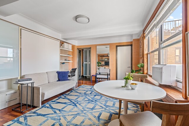 living room featuring dark wood-type flooring and beamed ceiling