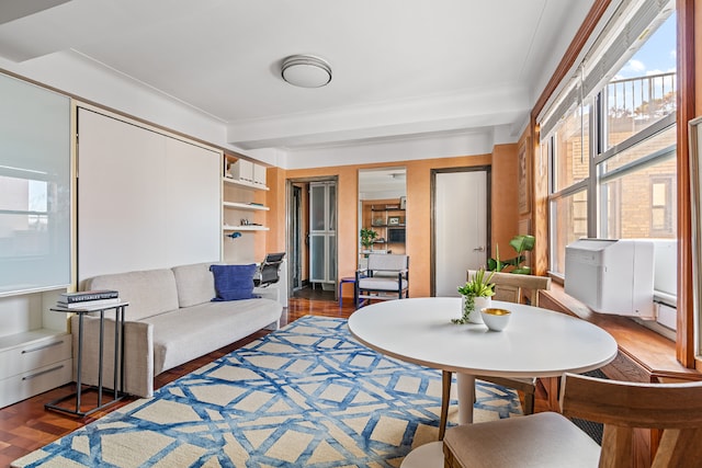 living room with beam ceiling and wood finished floors