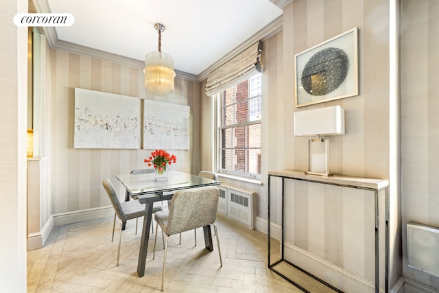 dining area with light parquet floors, ornamental molding, radiator heating unit, and an inviting chandelier