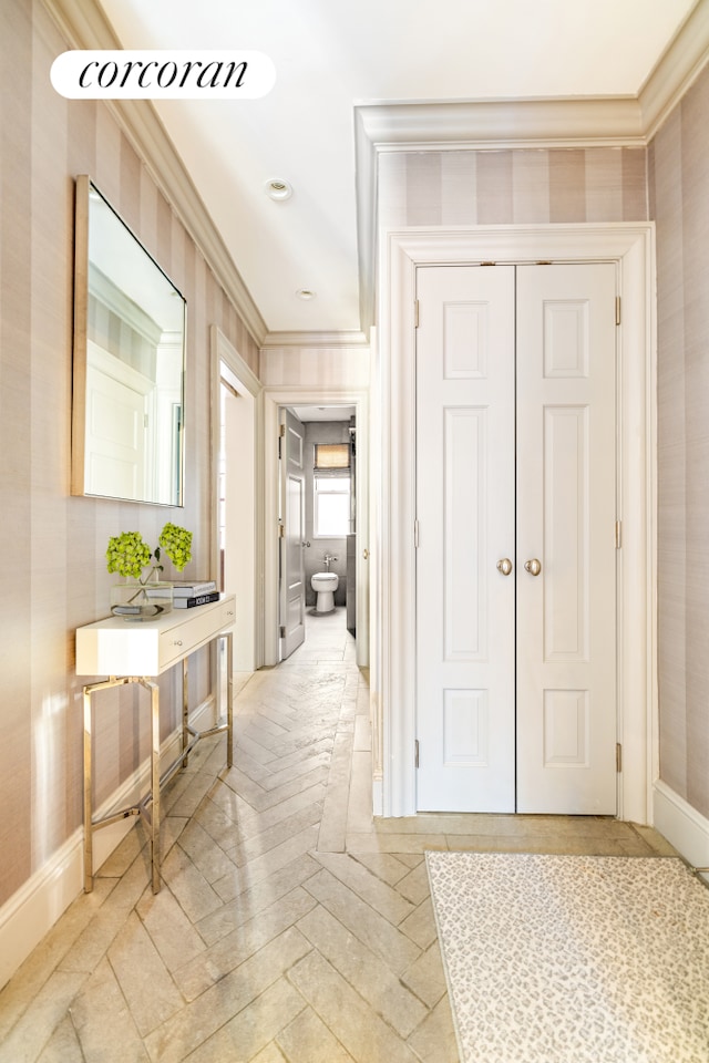 hall featuring baseboards and ornamental molding