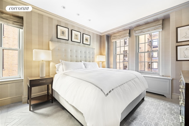 bedroom featuring visible vents, crown molding, baseboards, and wallpapered walls