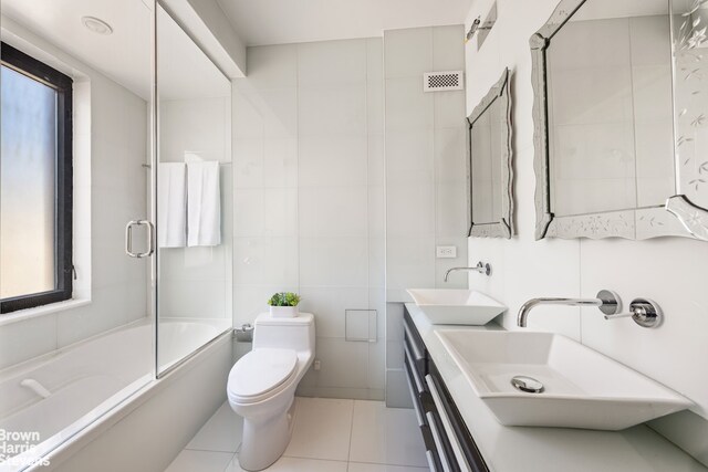 full bath with toilet, visible vents, a sink, and tile patterned flooring