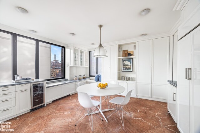 kitchen with white cabinets, open shelves, pendant lighting, and wine cooler