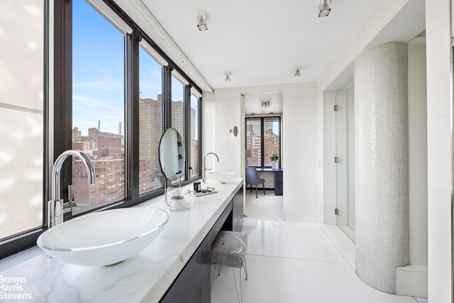 full bath featuring a sink, a view of city, and double vanity