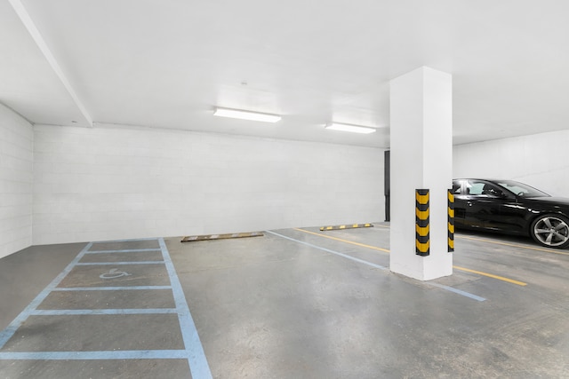 parking garage featuring concrete block wall