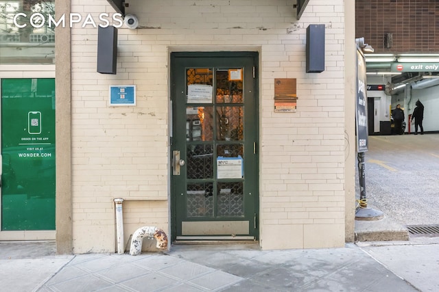 entrance to property with brick siding