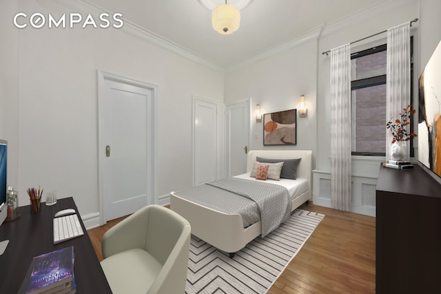 bedroom featuring crown molding and light wood-style floors