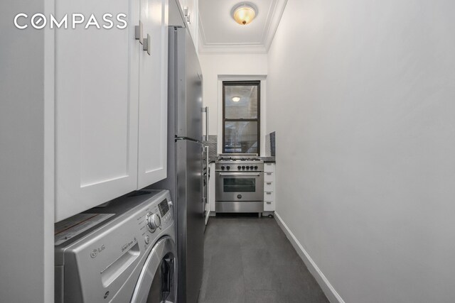 120 E 86th St Unit 3D, New York City, NY 10028 - laundry area featuring washer / clothes dryer, cabinet space, ornamental molding, and baseboards