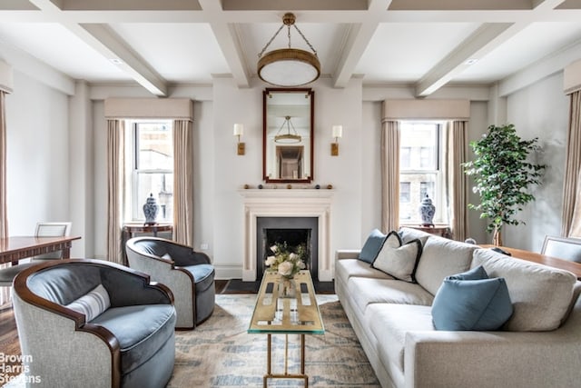 living area with plenty of natural light, beam ceiling, and a fireplace