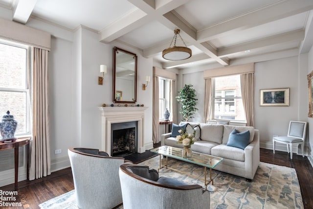 living area featuring baseboards, coffered ceiling, beam ceiling, a fireplace, and dark wood-type flooring