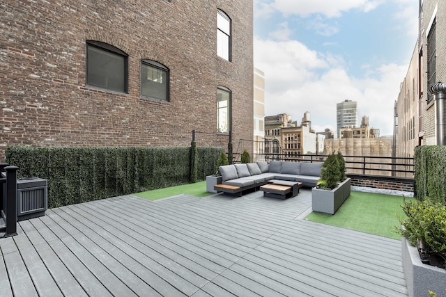 wooden terrace with outdoor lounge area and fence