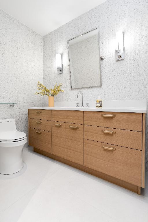 bathroom with toilet, wallpapered walls, tile patterned flooring, and vanity