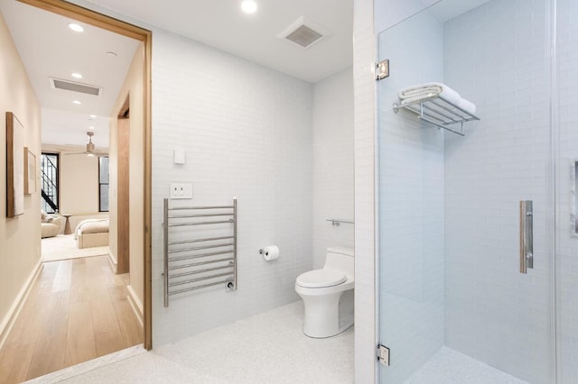 bathroom featuring toilet, recessed lighting, visible vents, a shower stall, and radiator