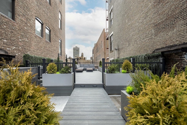 view of home's community featuring an outdoor living space, fence, and a deck