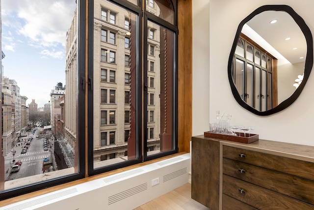 interior space featuring recessed lighting, a city view, and wood finished floors