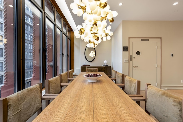 dining room featuring a chandelier and recessed lighting