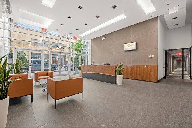 214 N 11th St Unit 1L, New York City, NY 11211 - building lobby featuring a high ceiling and floor to ceiling windows