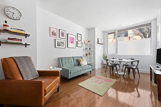 living area with wood finished floors and baseboards