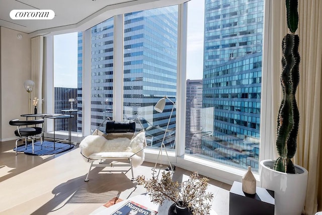 sitting room with a view of city and floor to ceiling windows