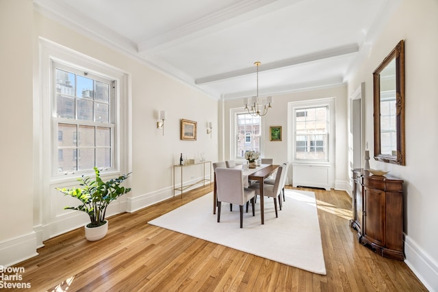 dining area featuring beamed ceiling, baseboards, an inviting chandelier, and hardwood / wood-style flooring