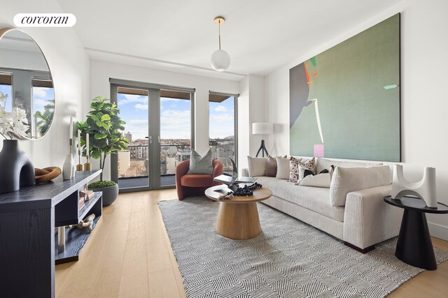 living area featuring visible vents and wood finished floors