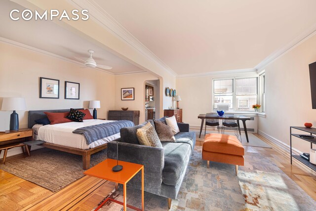 bedroom with ornamental molding, radiator heating unit, and ceiling fan