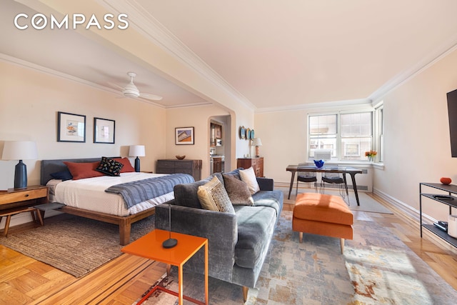 bedroom featuring baseboards, a ceiling fan, and crown molding