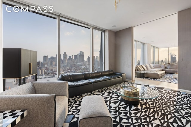 living area featuring floor to ceiling windows, a view of city, and a wealth of natural light