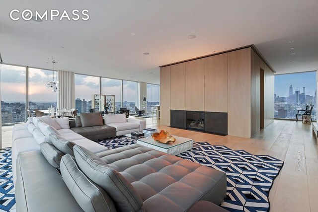 living room featuring expansive windows and light wood-type flooring