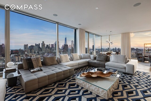 living room with plenty of natural light, a city view, and a chandelier