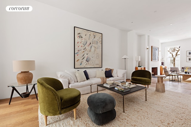 living room with light wood-style flooring and visible vents