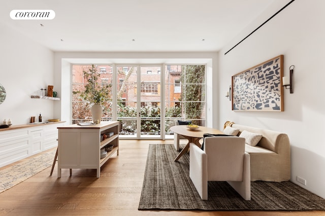 sitting room featuring visible vents and light wood-type flooring