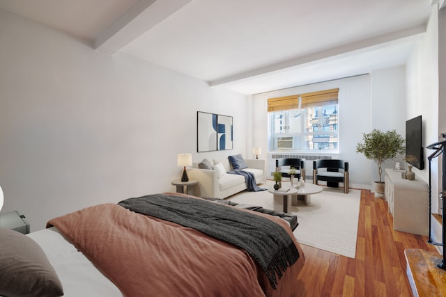 bedroom with beamed ceiling and light hardwood / wood-style flooring