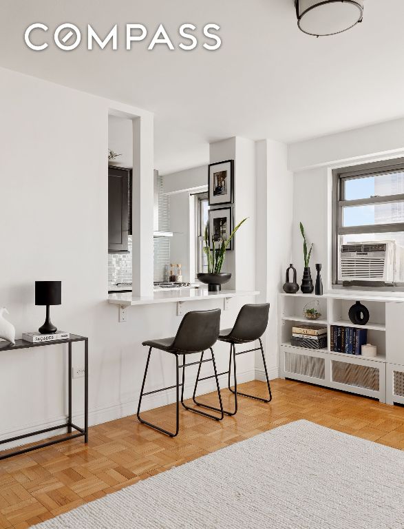 bar featuring cooling unit, backsplash, and light parquet floors