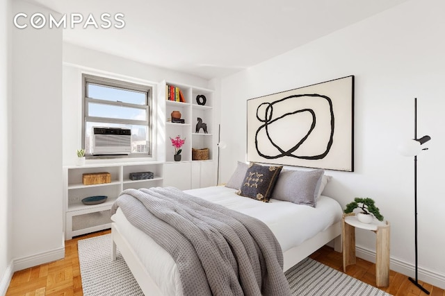 bedroom featuring cooling unit and light parquet floors