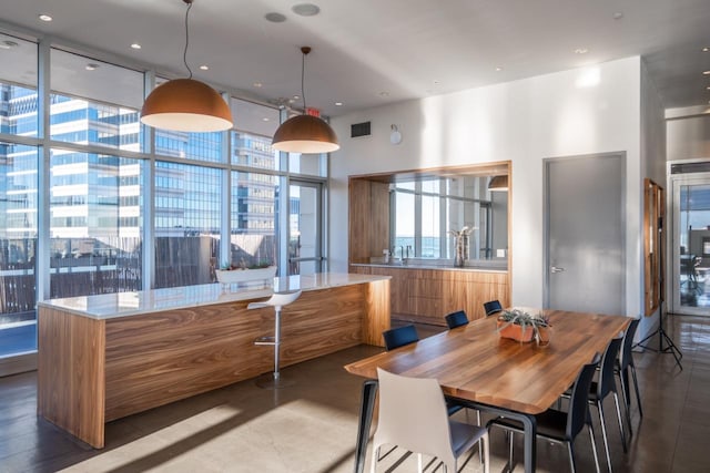 dining room featuring a wall of windows, recessed lighting, and visible vents