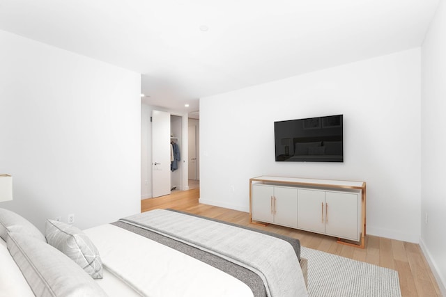 bedroom with recessed lighting, baseboards, and light wood finished floors