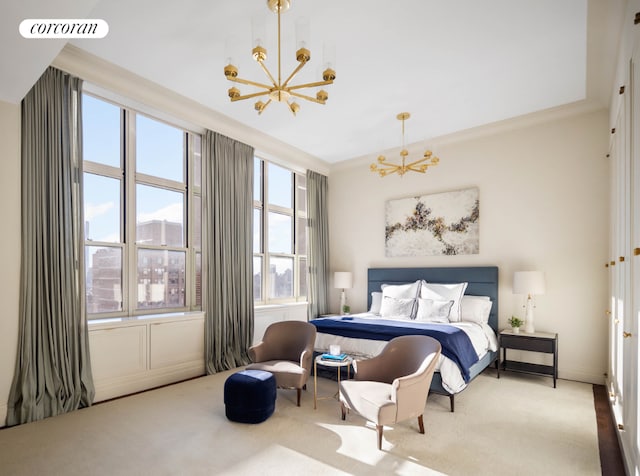 carpeted bedroom with ornamental molding and a chandelier