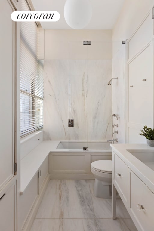 full bathroom with vanity, shower / bath combination with glass door, and toilet