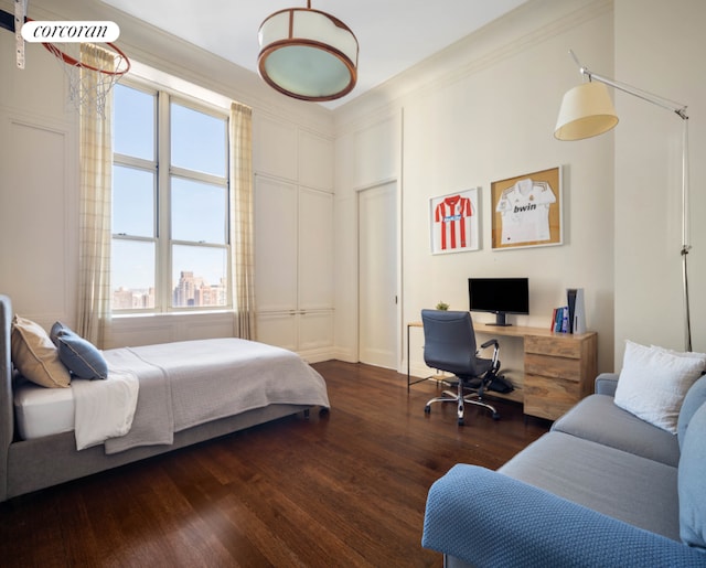 bedroom featuring ornamental molding and dark wood-style flooring