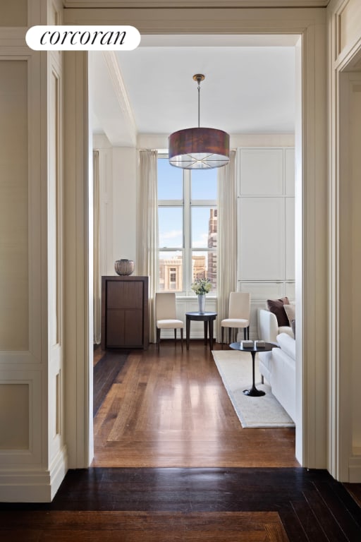 unfurnished room featuring ornamental molding and dark wood-type flooring