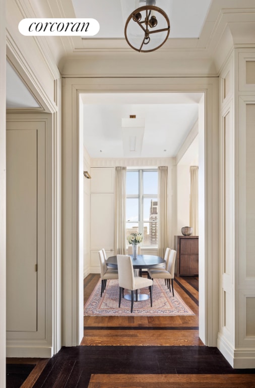 dining area with crown molding and dark hardwood / wood-style floors