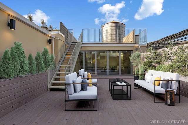 wooden terrace featuring outdoor lounge area and stairs