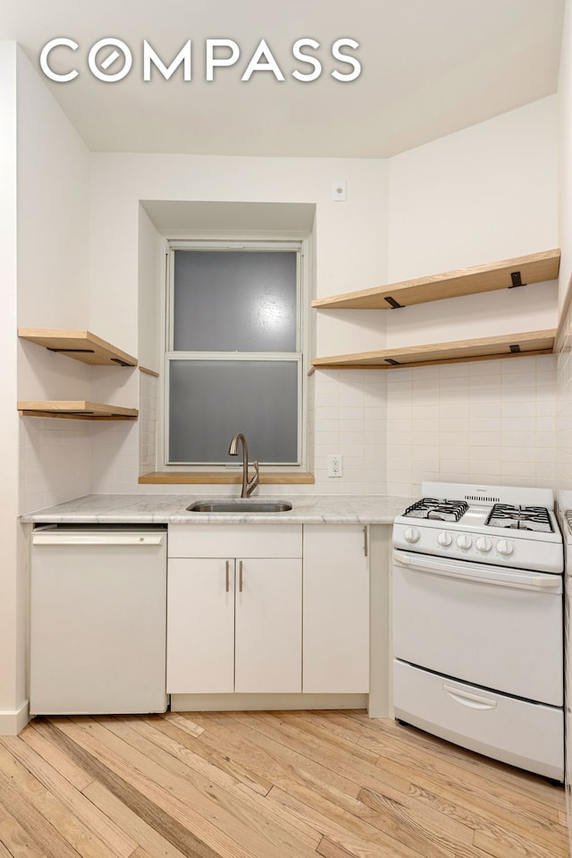 kitchen with open shelves, white appliances, backsplash, and a sink