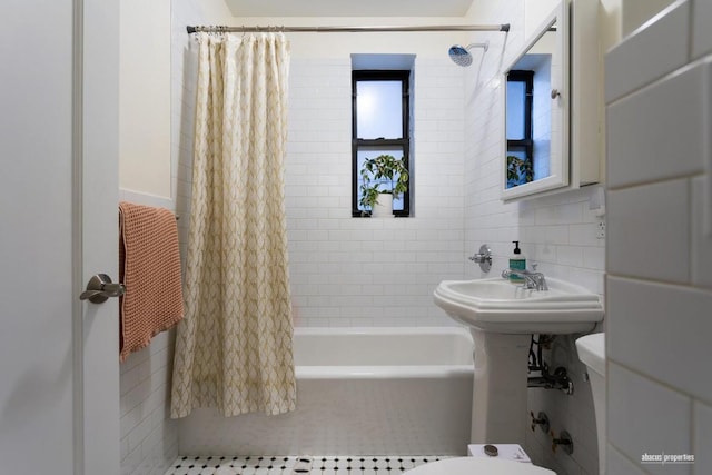 full bath with decorative backsplash, shower / tub combo with curtain, tile walls, and toilet