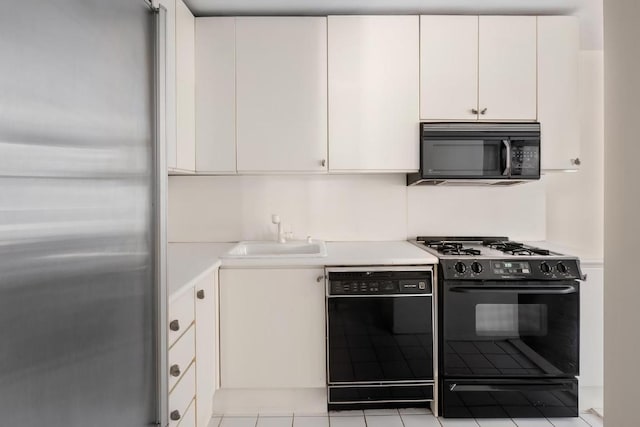 kitchen featuring white cabinets, sink, and black appliances