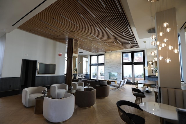 building lobby featuring wainscoting, wooden walls, and expansive windows